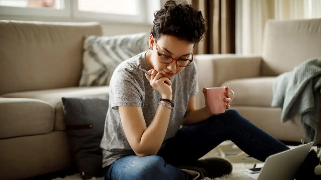 Young woman at home looking for more income