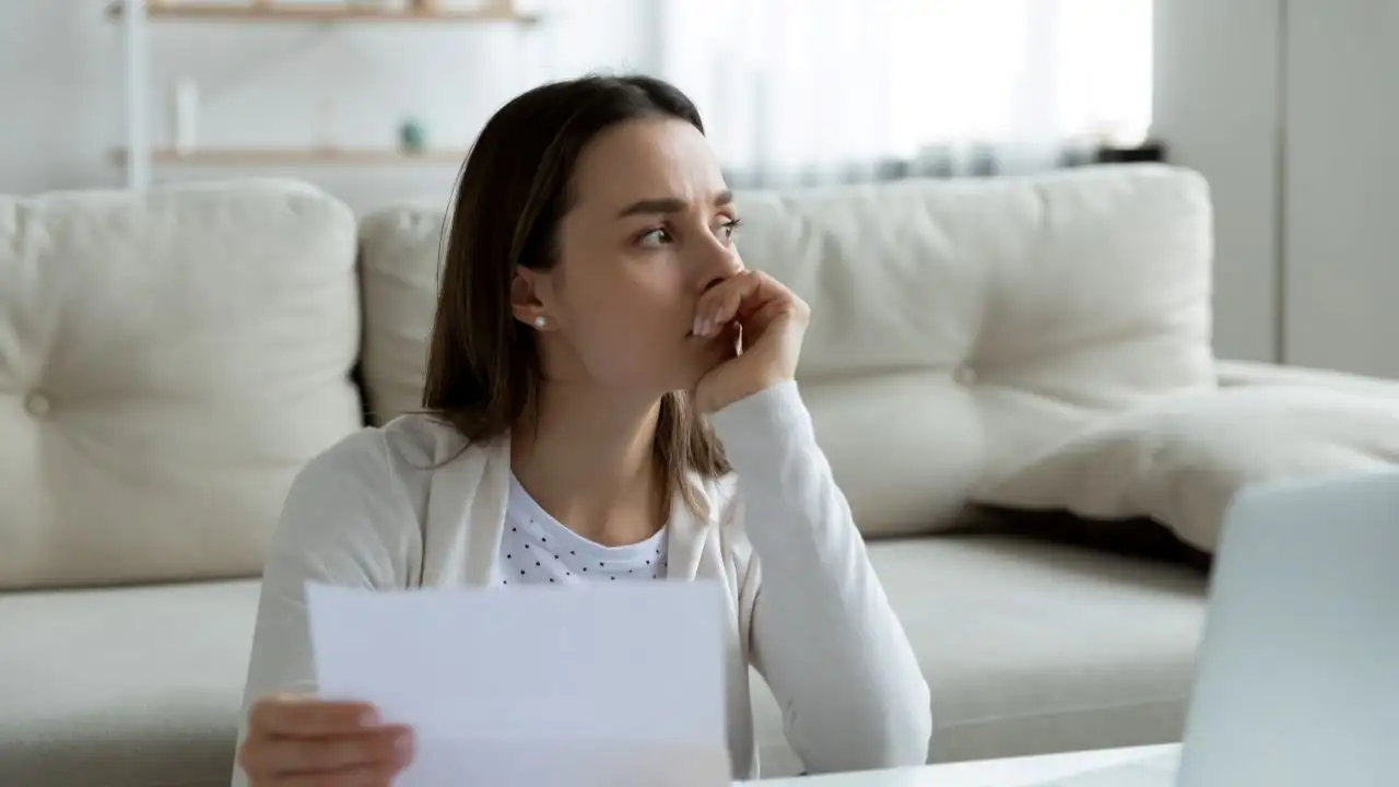 Young woman thinking about how to resolve medical bills