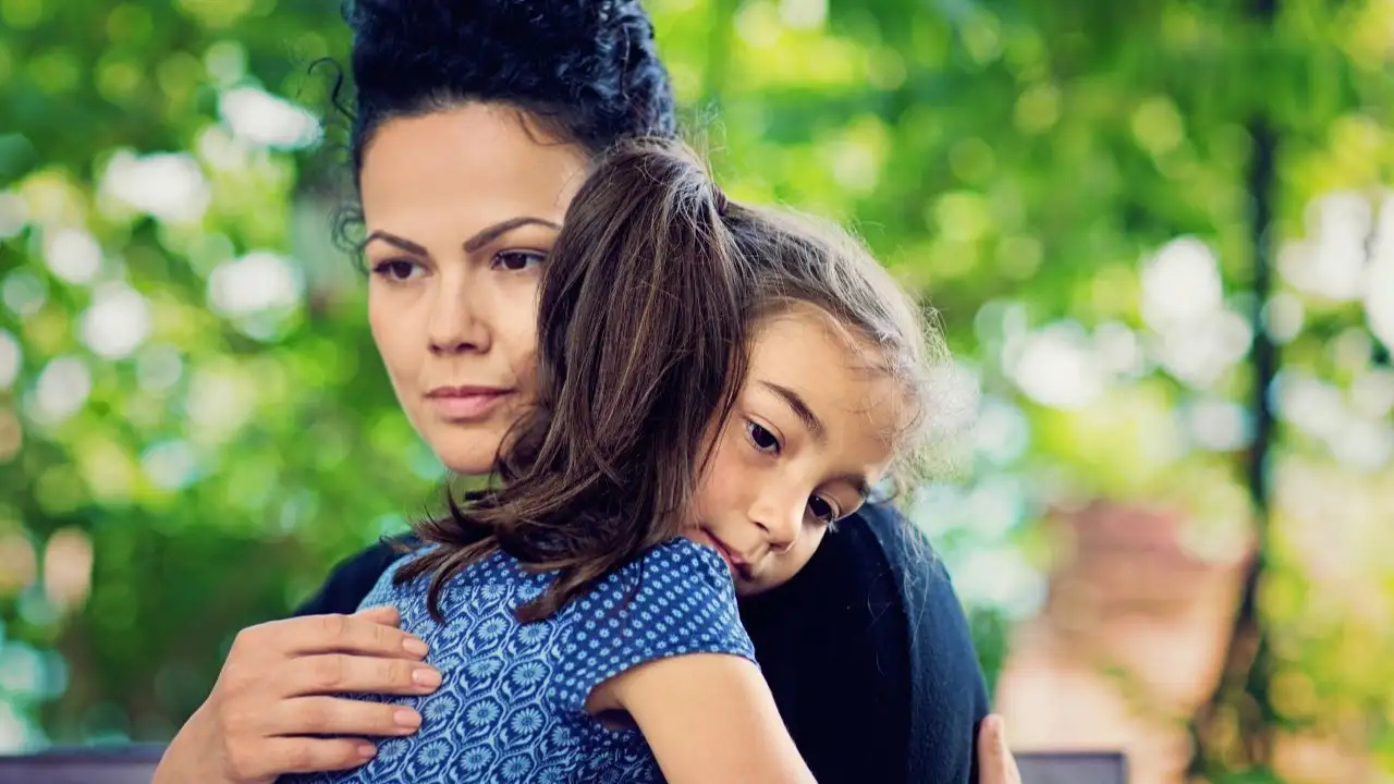 Mother is holding her beloved daughter.