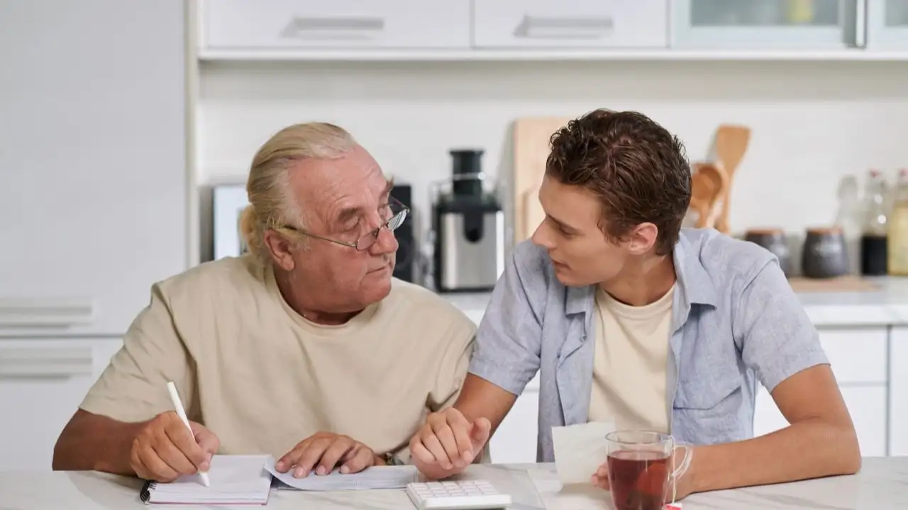 Young man asking grandfather to cosign a personal loan and reviewing budget