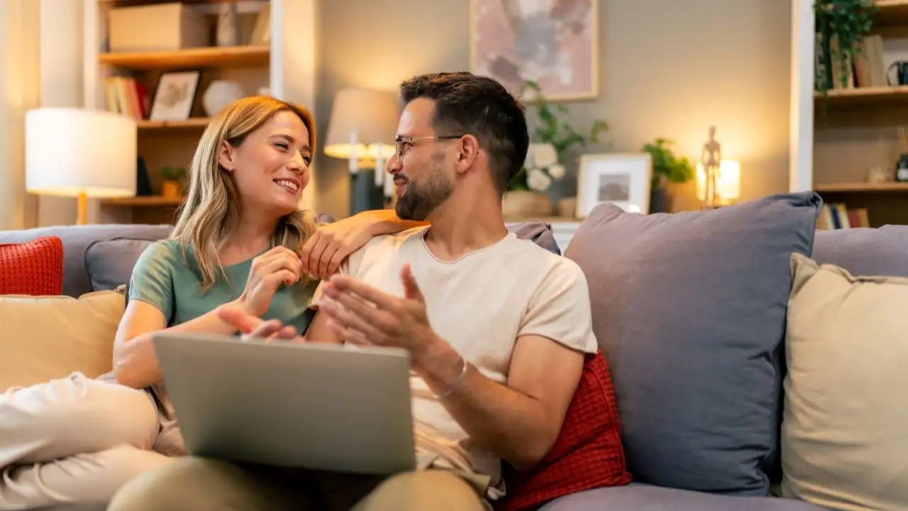 Couple paying bills online, calculate expenses at home