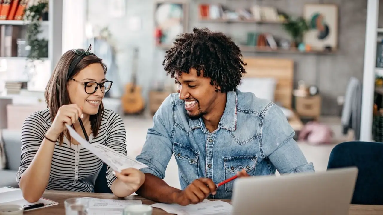 Young couple calculating financial bills at home