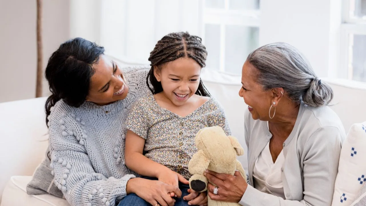 Dealing with death and financial hardship - mother and grandmother console young girl.