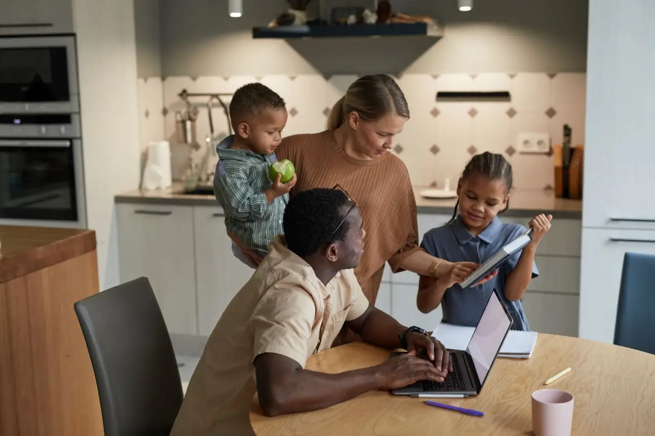 Family with two kids in kitchen talking together