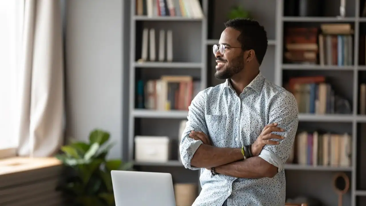 Man looking out the window dreaming about future