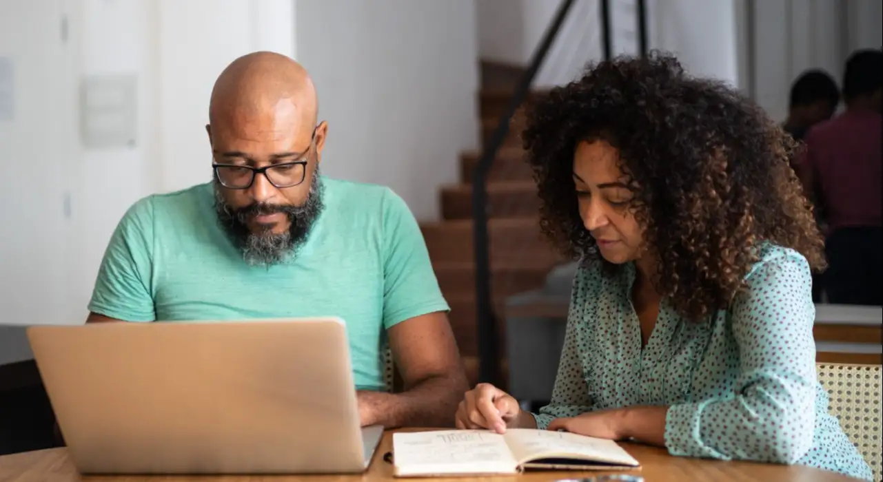 Couple sitting at table and reviewing finances