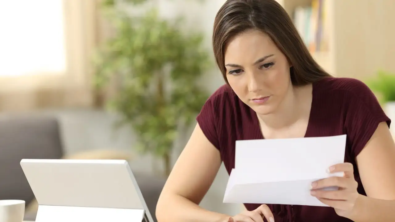 Young woman checking documents to provide to lender